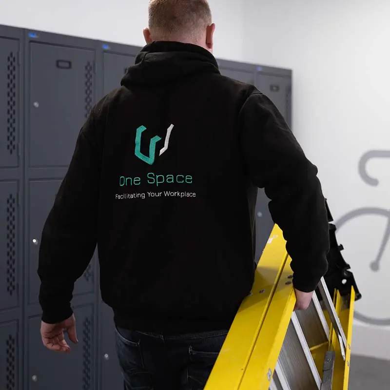 A One Space engineer arriving on site with a ladder
